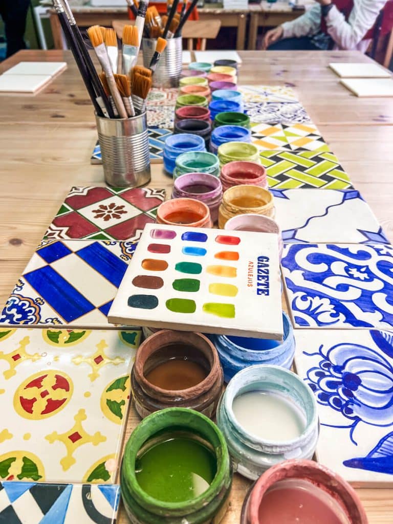 Paints, brushes and tile samples at Gazete Azulejos tile painting workshop in Porto, Portugal