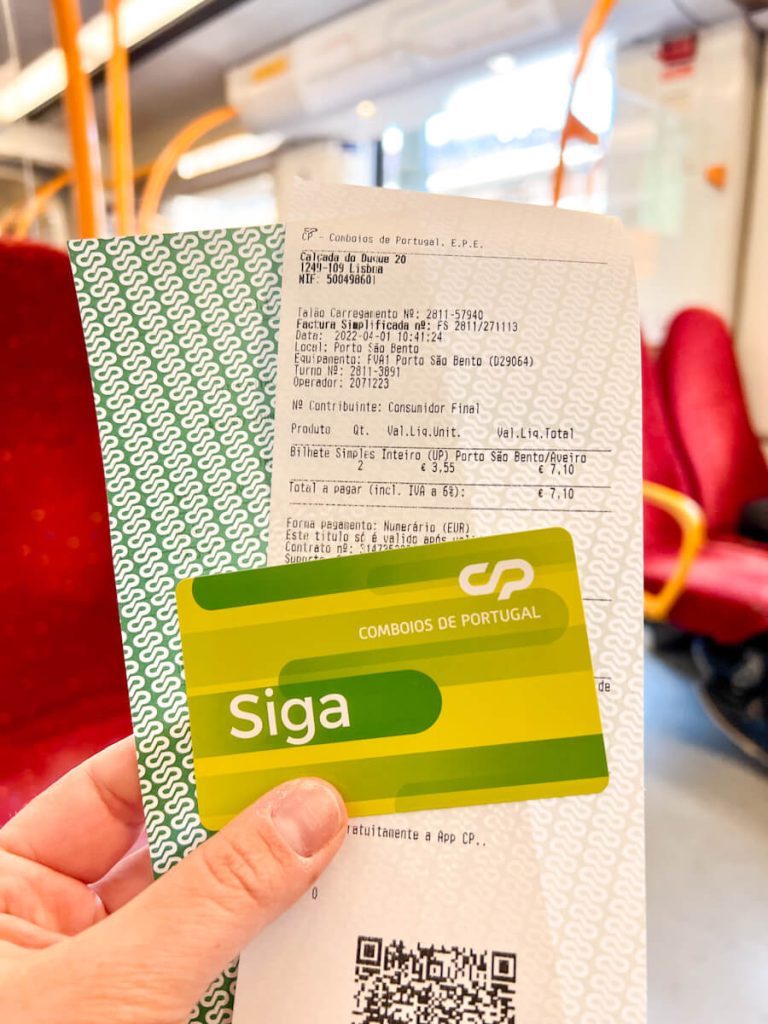 Picture of train pass and receipt taken inside an empty train car in Portugal