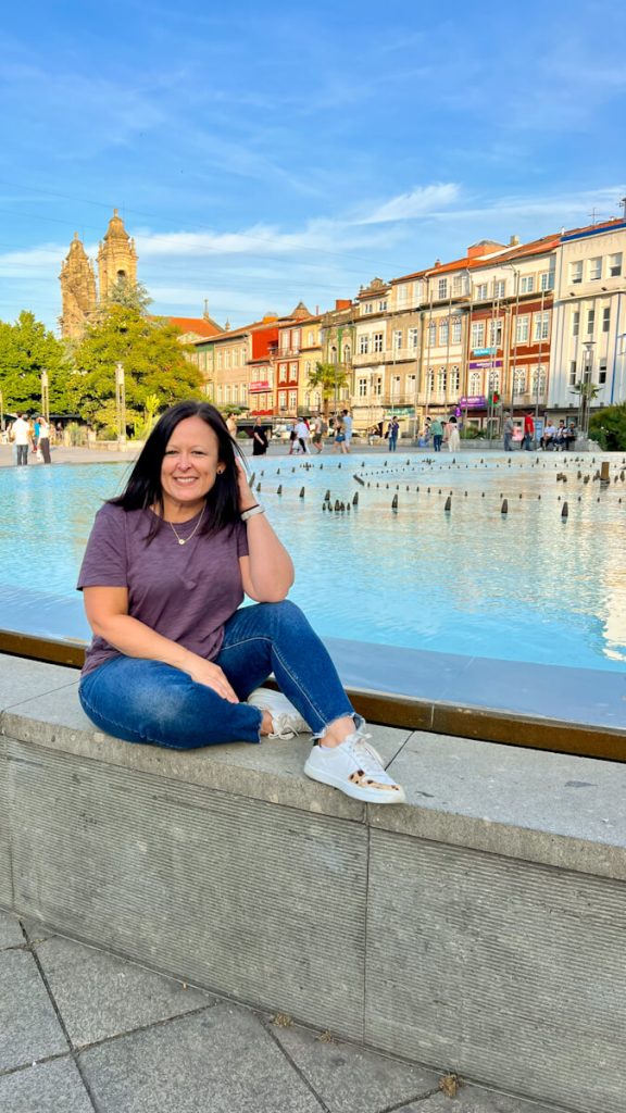 Girl posing in front of fountain in Braga, Portugal city center