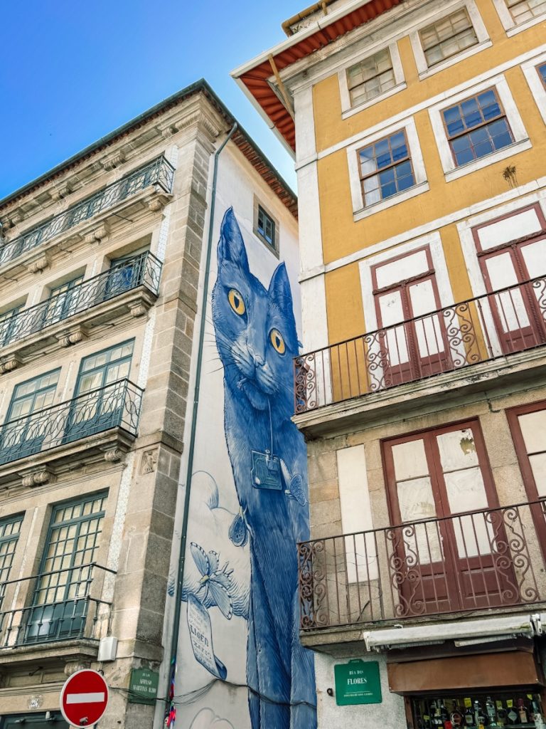 Blue cat mural on a building on Rua das Flores in Porto, Portugal