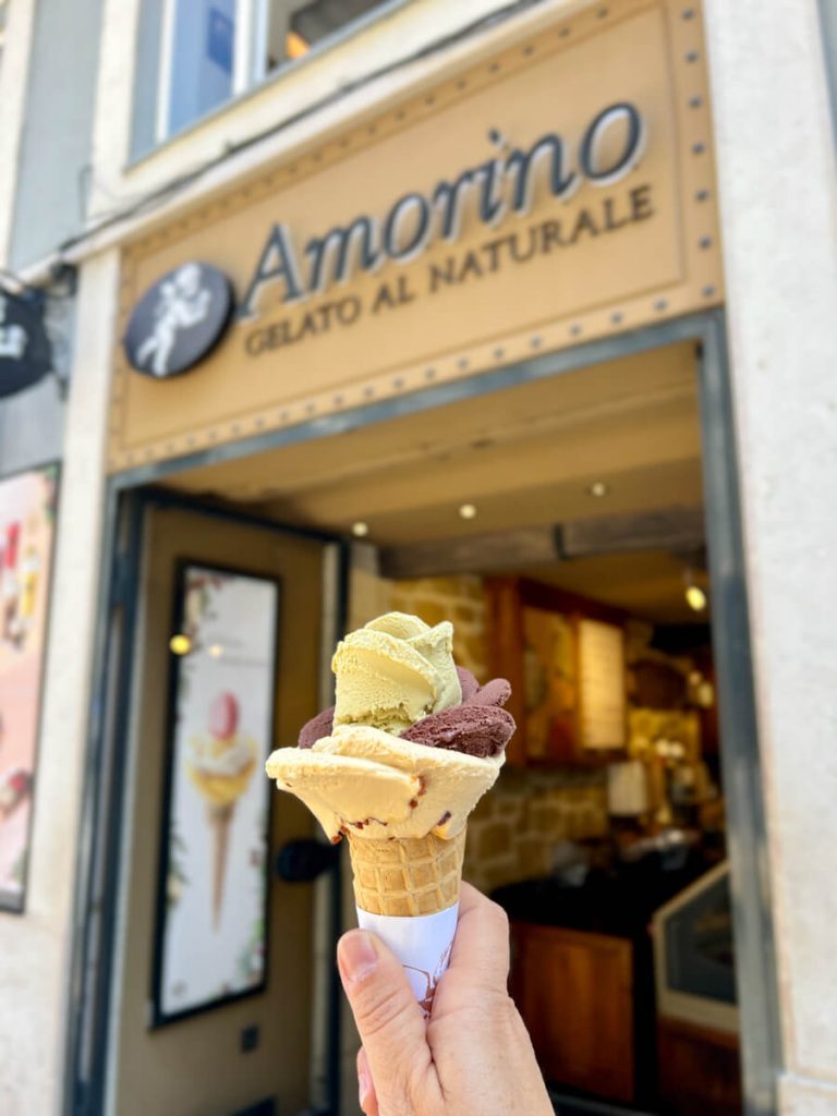 a cone of gelato from Amorino, made in a flower petal design