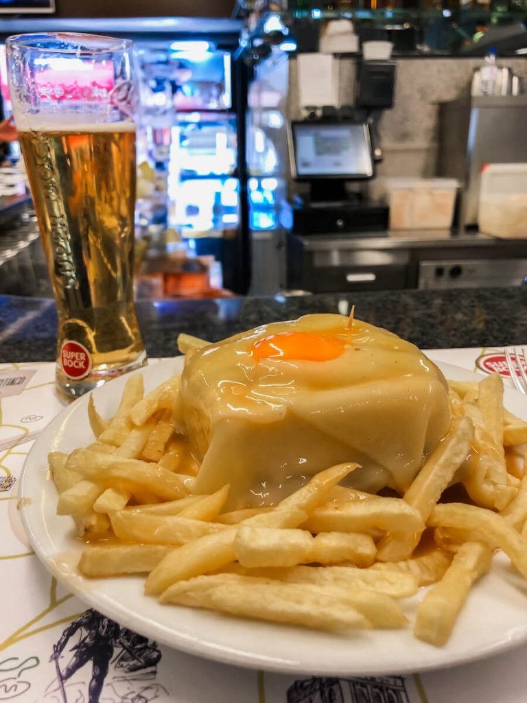 Portuguese Francesinha sandwich at the counter of Cafe Santiago in Porto