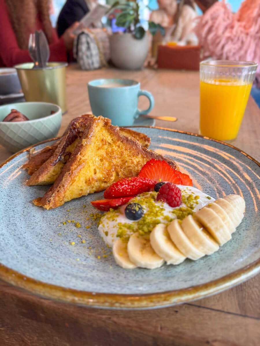 Plate of French toast, yogurt and berries, coffee and orange juice at Nicolau in Porto, Portugal